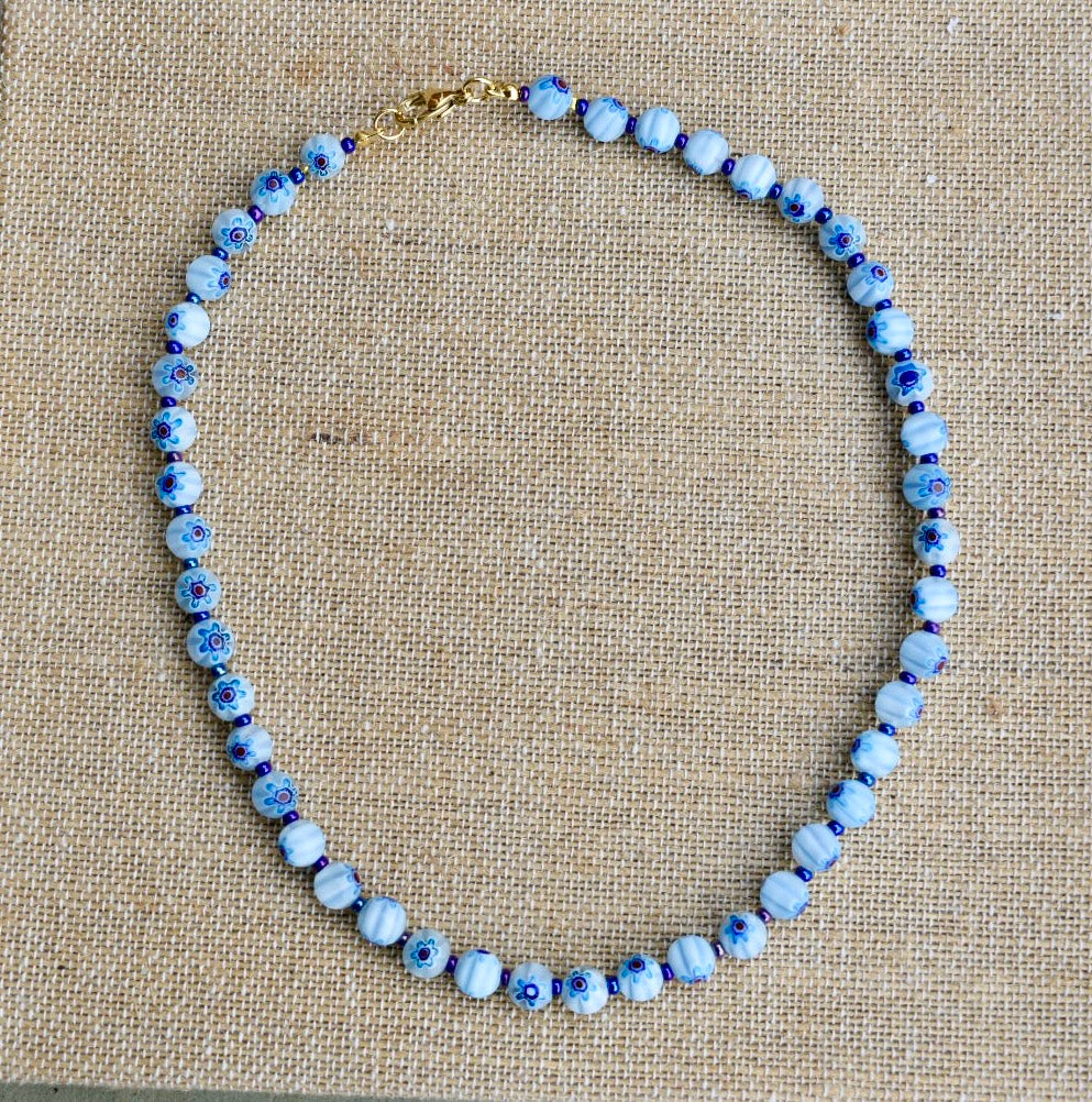 Colar Millefiori de vidro, azul-claro, sobre tecido de linho
