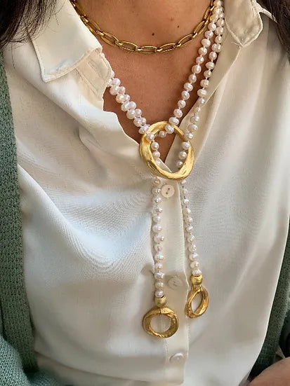 Colar Nina de pérolas com ágata azul, usado ao pescoço com camisa branca